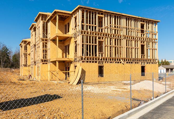 a close-up of temporary chain link fences enclosing a job site, signaling progress in the project's development in West Jordan UT